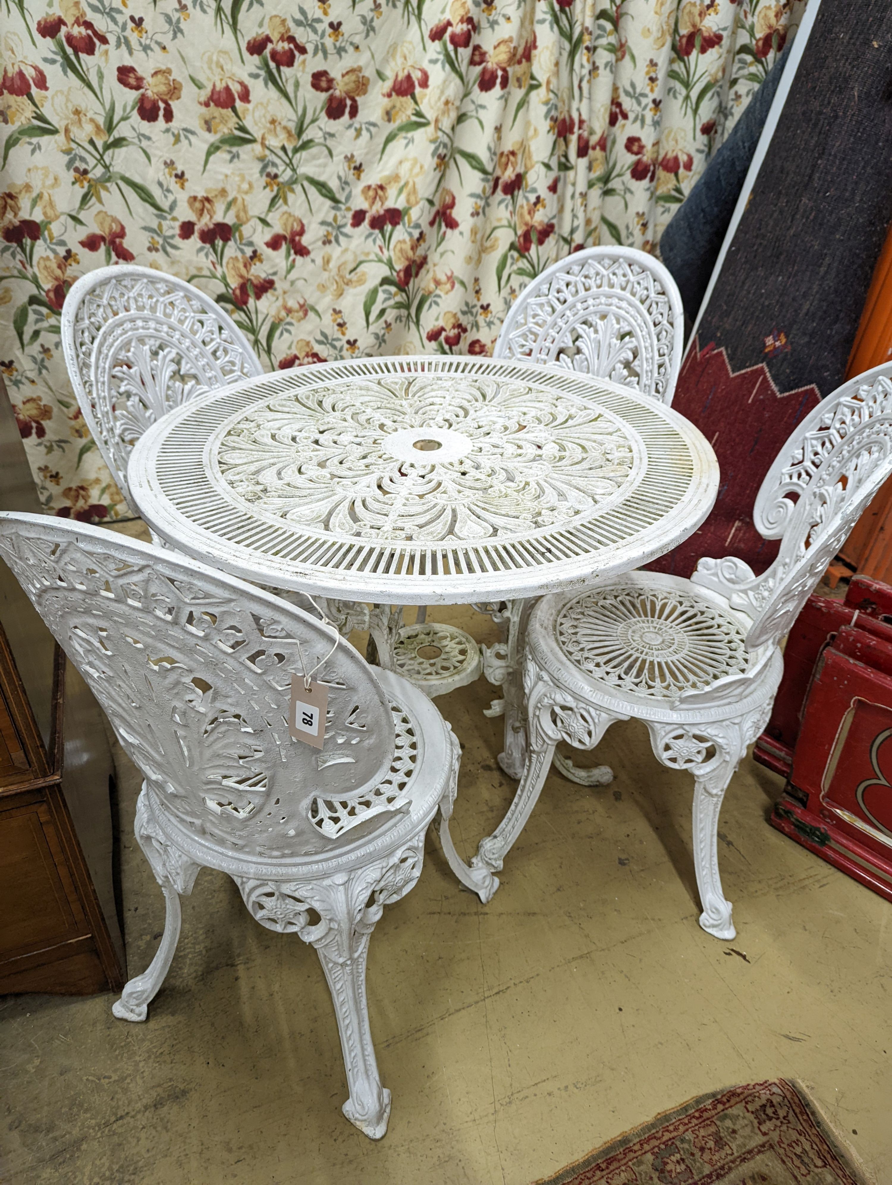 A Victorian style painted aluminium circular garden table, diameter 80cm, height 70cm and four chairs